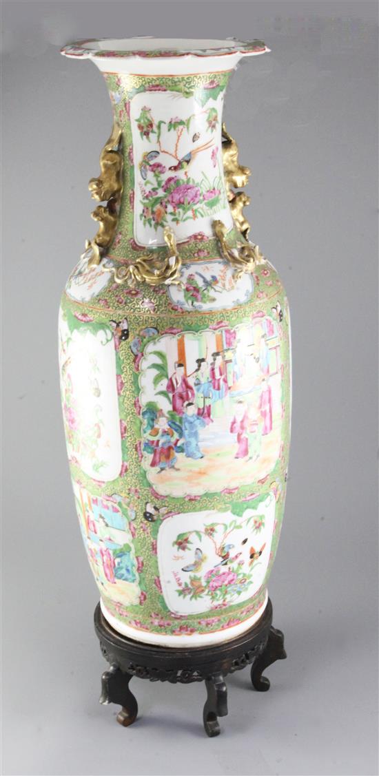 A large Chinese Canton-decorated famille rose baluster vase, 19th century, height 63cm, wood stand